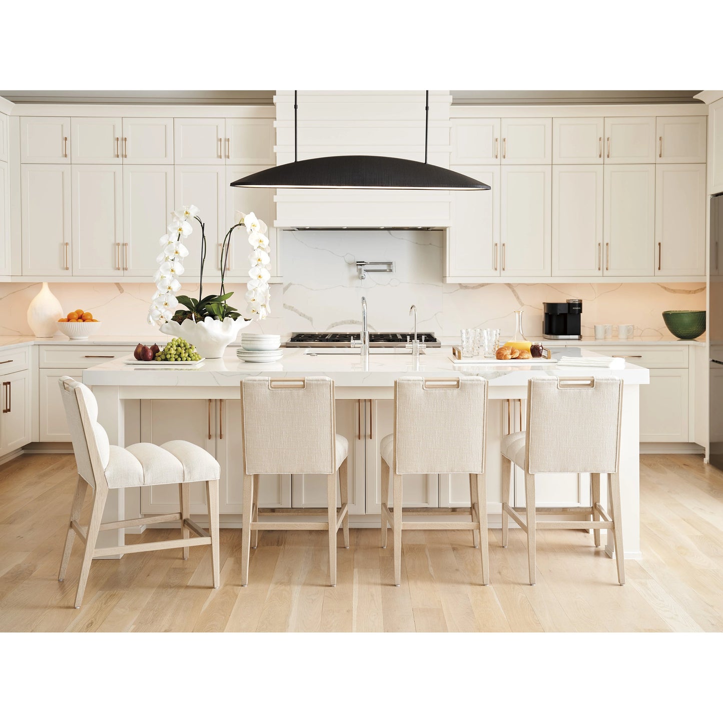 003 SI-2136896 | Lifestyle | Greer Channeled Upholstered Counter Stool by Tommy Bahama Home in sand drift. Made from unique in a modern style.