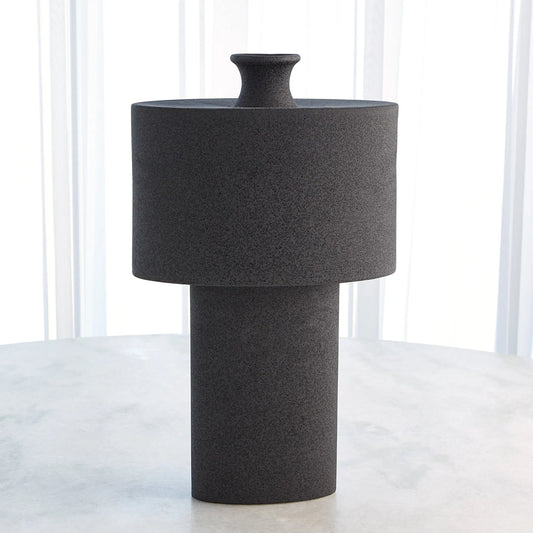 Folk Oval Drum Vase by Global Views in black stone. Made from earthenware in a modern style.