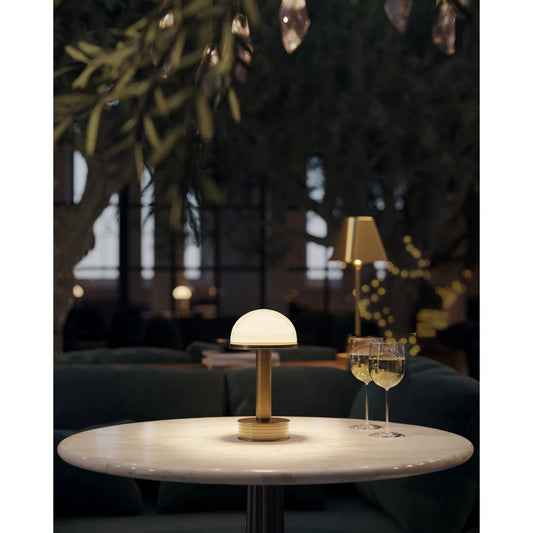 Promenade Cordless Table Lamp by Currey and Company in antique brass, milk. Made from metal, glass in a modern style.