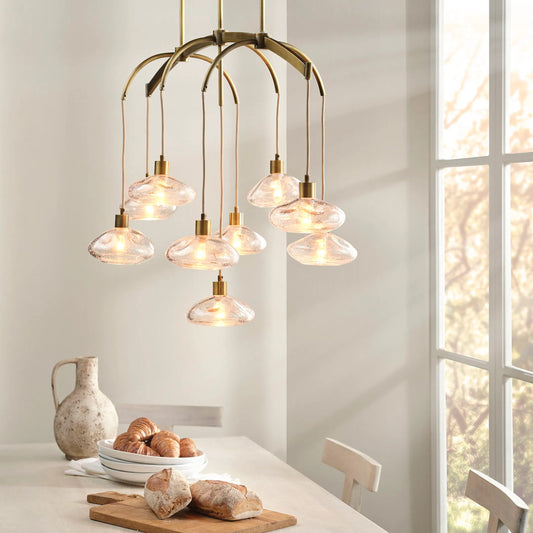 Reservoir Chandelier by Jamie Young in antique brass. Made from glass in a unique style.