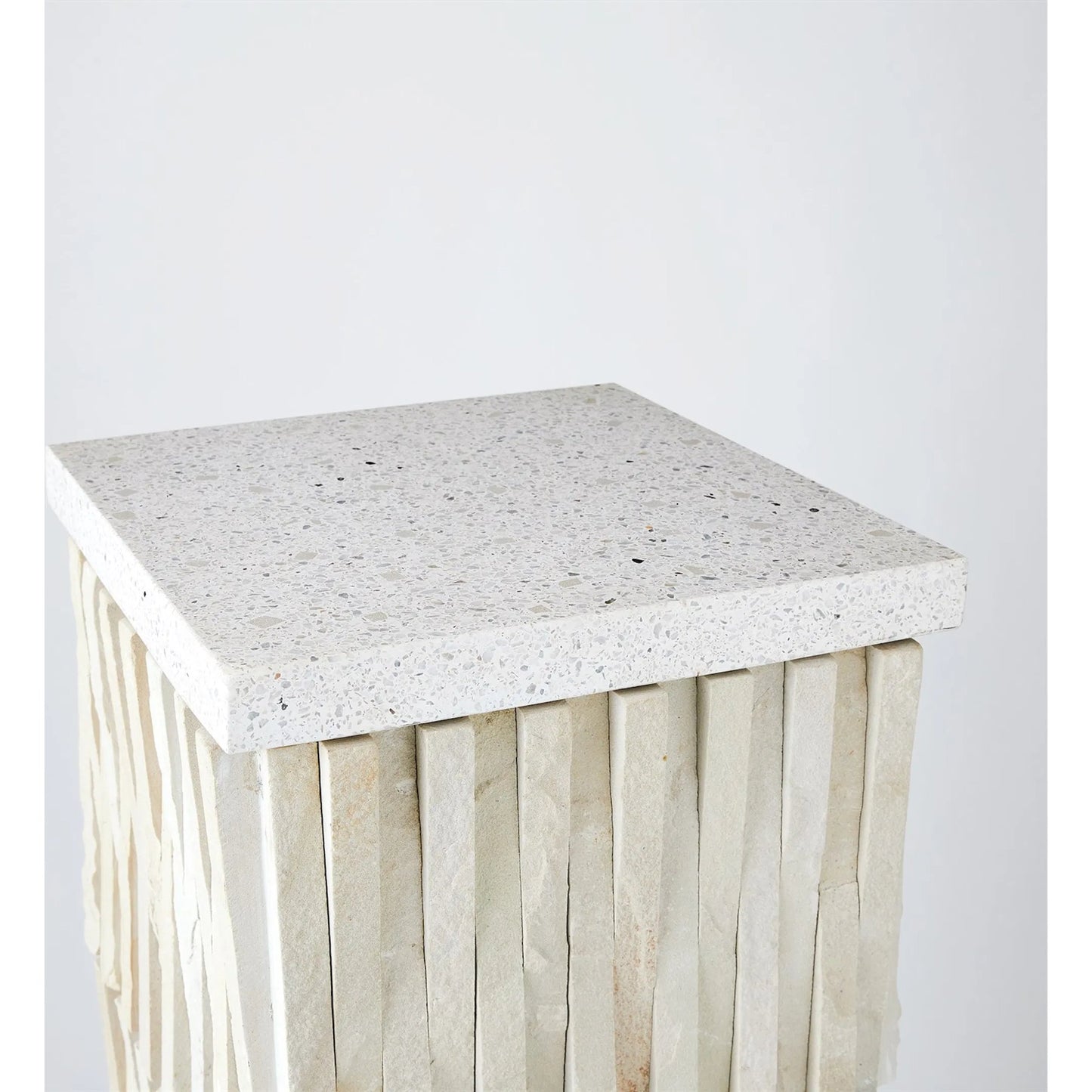 002 SR-702174 | Closeup | Teeter Totter Pedestal by Global Views. Made from hand sculpted chiseled stone from rajasthan, terrazzo top in a eclectic & global style.
