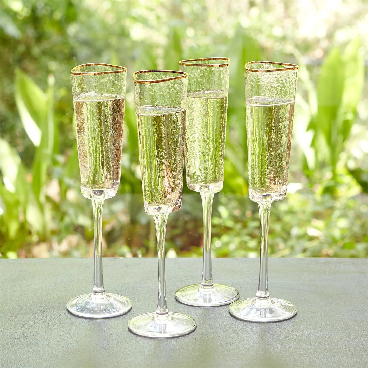 003 SR-893008 | Lifestyle | Hammered Champagne Glasses by Global Views in clear w, gold rim. Made from glass in a transitional style.