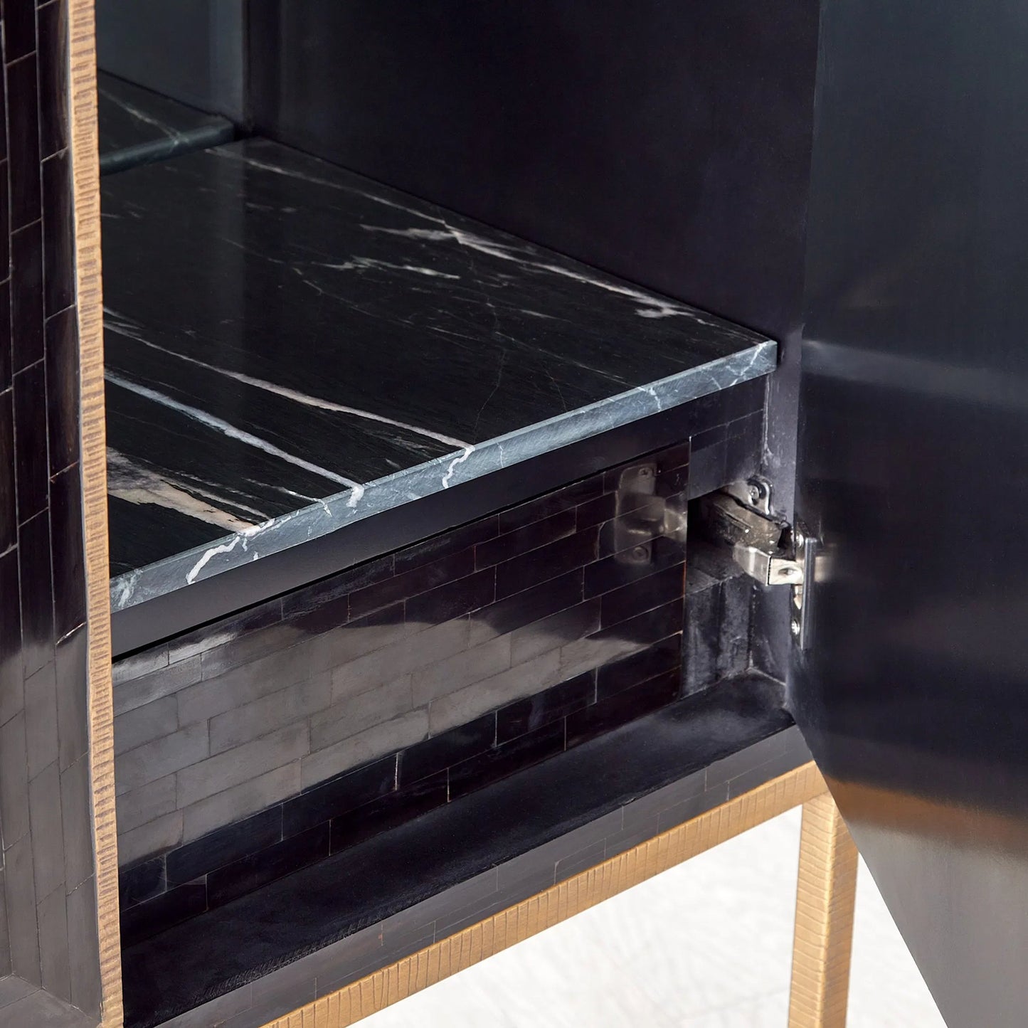 003 SI-2445928 | Closeup | Horn Inlay Bar Cabinet by Global Views in black, antique brass. Made from mdf, buffalo horn cladded, iron, 10mm thick tempered glass, marble in a modern style.