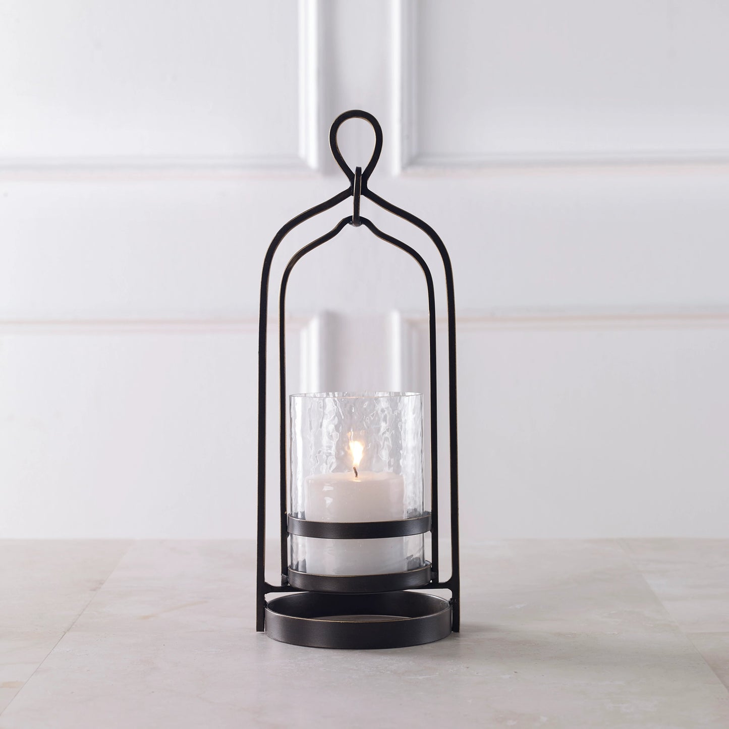 002 SI-1981240 | Lifestyle | Shepherd Candleholder by Uttermost in dark bronze. Made from iron, glass in a modern style.