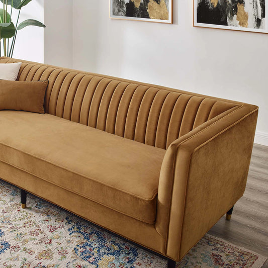 Harrison Channel Sofa by Evans & Londeen in cognac. Made from yuhua velvet fabric, 100% polyester, m3, 60mmt foam density, non-woven fabric cover, rubber wood legs painted in black in a modern style.