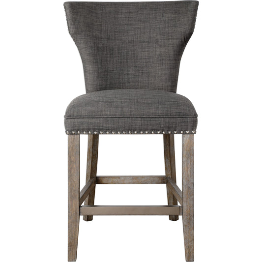 Arnaud Charcoal Counter Stool by Uttermost in charcoal. Made from solid wood, plywood, fabric, foam in a cottage & farmhouse style.