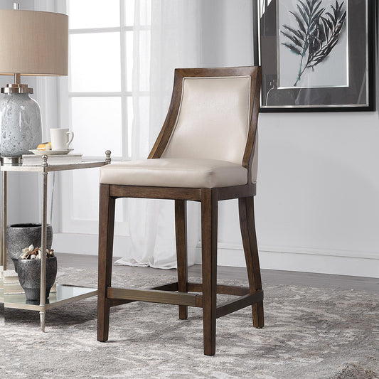 Purcell Leather Counter Stool by Uttermost. Made from rubber wood, plywood, foam, fabric in a transitional style.