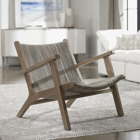 Aegea Rattan Accent Chair by Uttermost. Made from mango wood with rattan weaving in a coastal style.