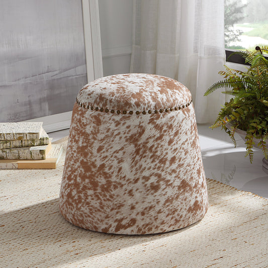 Gumdrop Cow Hide Ottoman by Uttermost in chestnut, white and brass. Made from plywood, foam, fabric in a rustic style.
