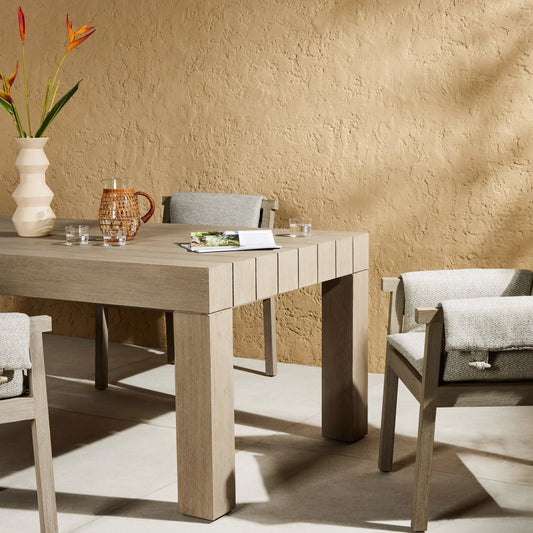 Sonora Outdoor Dining Table by Four Hands in weathered grey. Made from solid teak in a modern style.