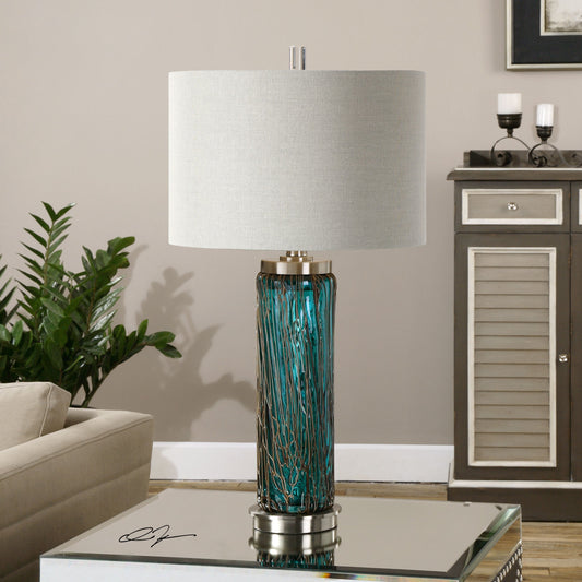 Almanzora Lamp by Uttermost in blue. Made from glass, metal, fabric in a modern style.