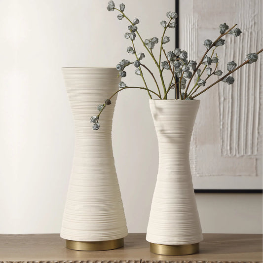 Ridgeline Vases by Uttermost in gold. Made from ceramic, iron in a transitional style.