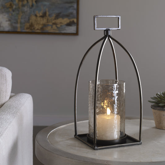 Riad Lantern Candleholder by Uttermost in dark bronze. Made from iron, glass in a rustic style.