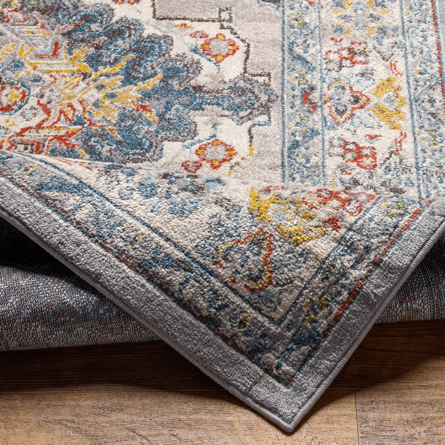 005 SI-2167436,SI-2167437 | Closeup | Ankara Rug by Livabliss in gray, taupe, ice blue, dark blue, cream, rust. Made from polypropylene in a unique style.