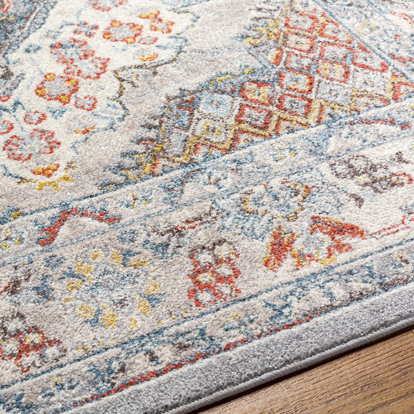006 SI-2167436,SI-2167437 | Closeup | Ankara Rug by Livabliss in gray, taupe, ice blue, dark blue, cream, rust. Made from polypropylene in a unique style.