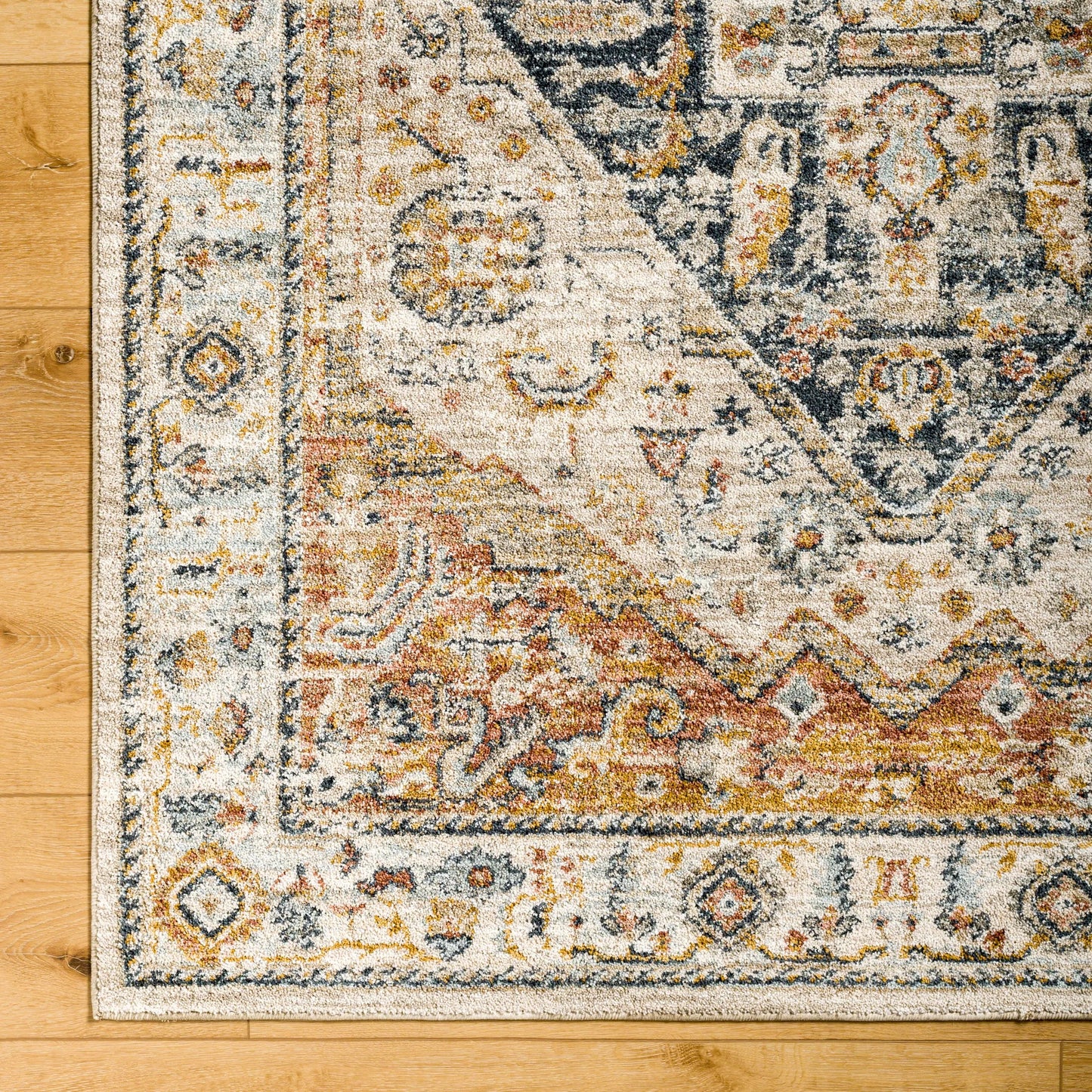 005 SI-1971441,SI-1971442,SI-1971443,SI-1971444,SI-1971445 | Closeup | Beckham Rug by Livabliss in off-white, amber, charcoal, light slate, ice blue, medium brown. Made from main: 100% polyester in a traditional style.