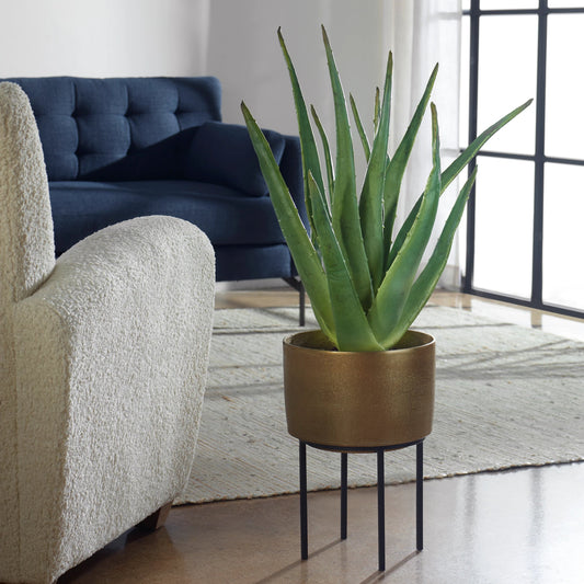 Arabia Aloe Planter by Uttermost in brass. Made from foam, aluminum, cement, iron in a modern style.