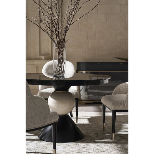 Chalice Dining Table by Caracole in almost black, brushed gold. Made from asian hardwood, acacia, glass, ceramic, metal in a modern style.