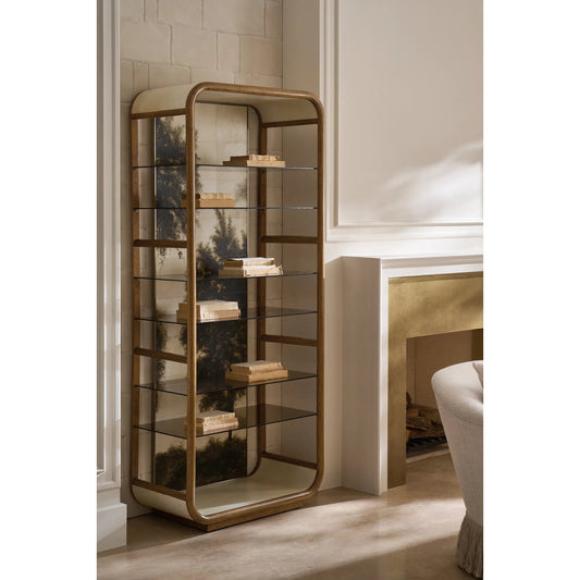 Fairmont Bookcase by Caracole in toasted sycamore, brushed gold, brushed gold paint, ivory parchment. Made from asian hardwood, metal, glass in a transitional style.
