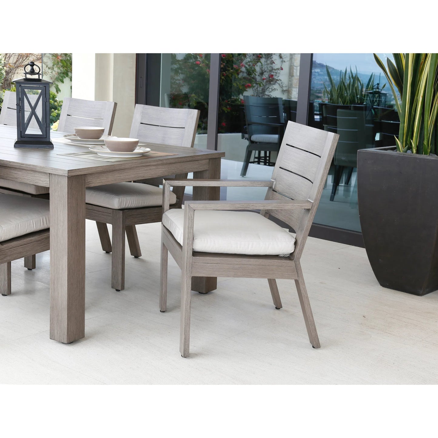 007 SI-2166945 | Lifestyle | Laguna Outdoor Dining Chair by Sunset West in driftwood. Made from aluminum in a modern style.