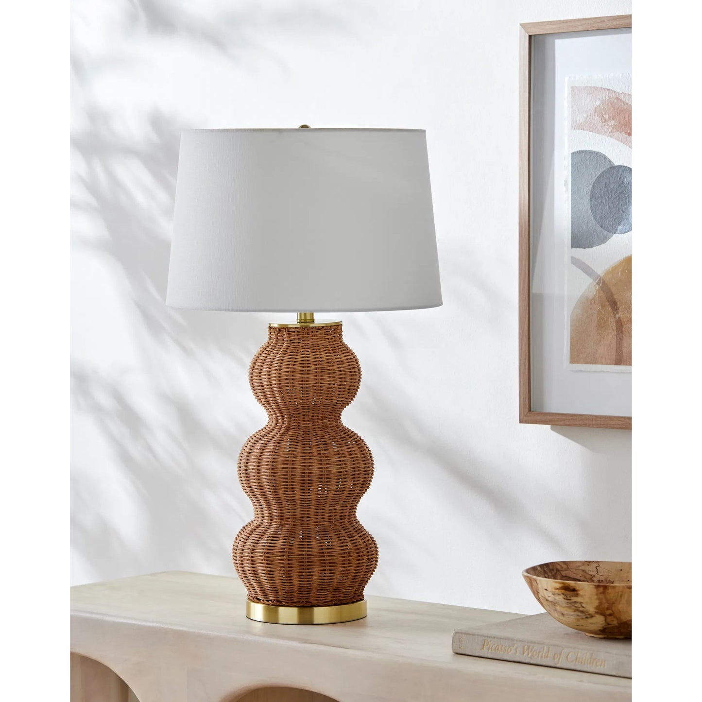 002 SI-2168168 | Lifestyle | Cazorla Table Lamp - 532384 by Livabliss in body: tan, base: metallic - brass, shade: white, finial: metallic - brass, harp: metallic - brass, cord: translucent and platedpaintedplated. Made from rattan, iron, linen, polystyren