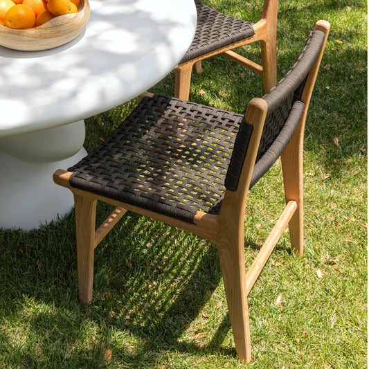 Albano Outdoor Dining Chair by Arch & Plane in natural, black. Made from teak wood, all-weather flat weave rope in a transitional style.
