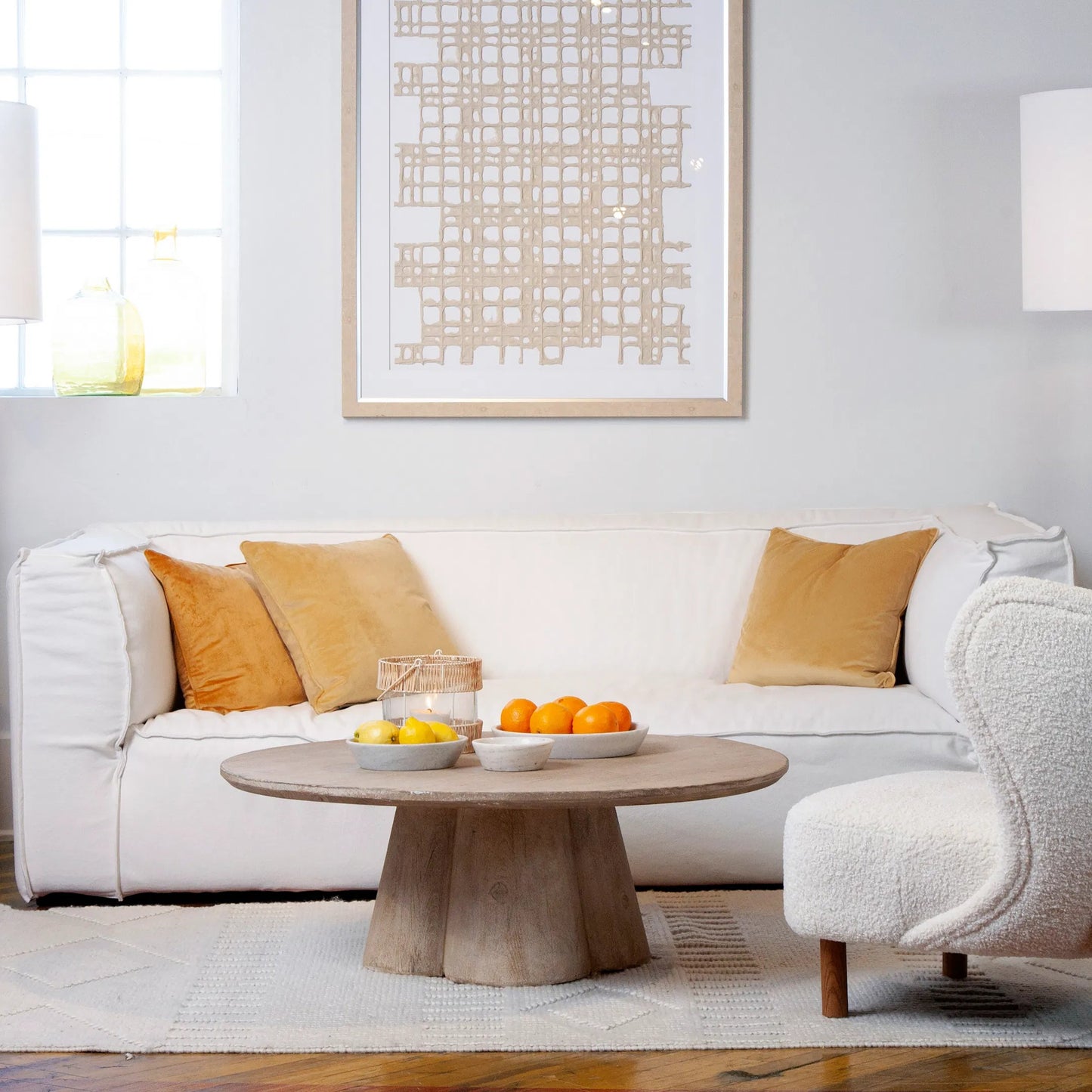 004 SI-1924496 | Lifestyle | Kristal Reclaimed Pine Round Coffee Table with Clover Pedestal by Arch & Plane in light wash brown. Made from reclaimed pine in a modern style.