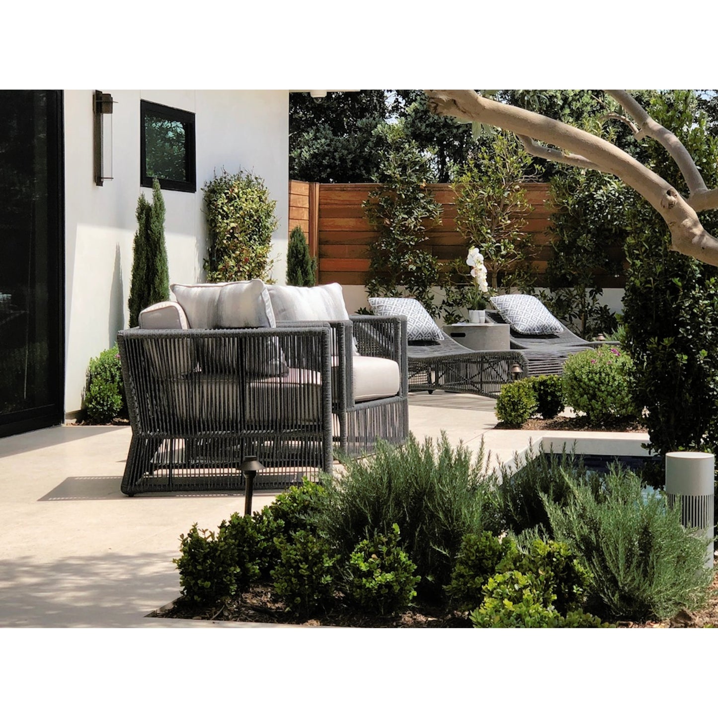 006 SI-2167040 | Lifestyle | Milano Outdoor Cushionless Chaise by Sunset West in slate. Made from olefin rope in a coastal style.