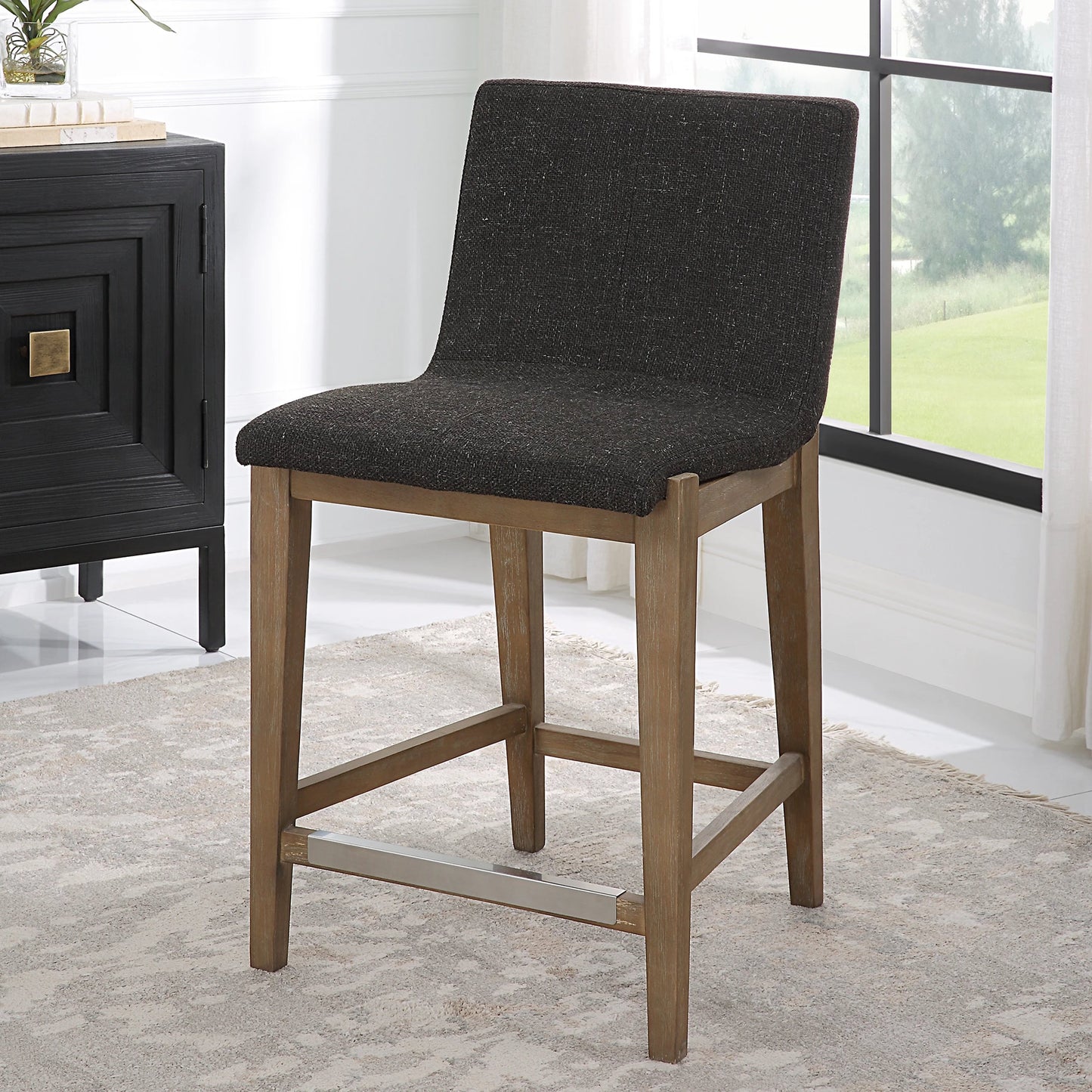003 SI-2146865 | Lifestyle | Klemens Counter Stool by Uttermost in charcoal brown and walnut. Made from rubber wood,plywood,fabric,foam,hardware in a modern style.