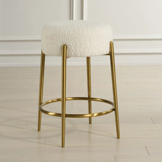 Arles Counter Stool by Uttermost in brass. Made from stainless steel, plywood, hardwood, fabric, foam in a transitional style.