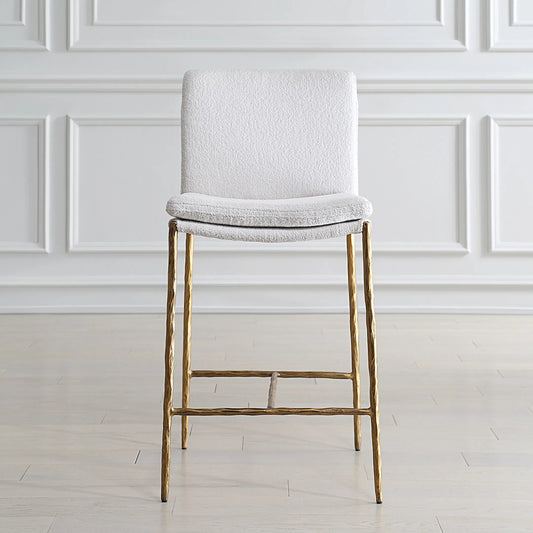 Ascend Counter Stool by Uttermost in gold. Made from metal, plywood, foam, fabric in a transitional style.