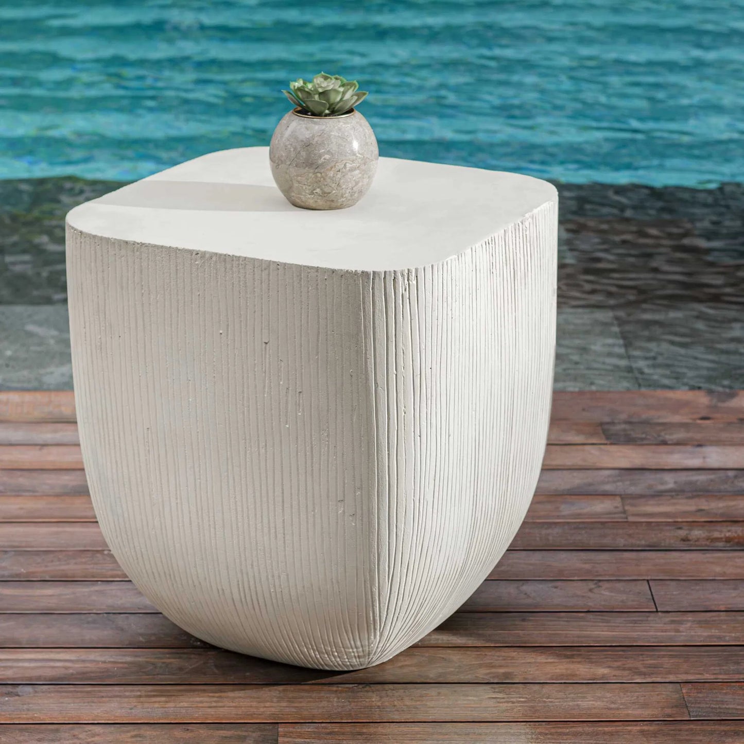001 SI-2386838 | Lifestyle | Alma Outdoor Side Table by Uttermost in limestone. Made from glass fiber reinforced concrete in a modern style.