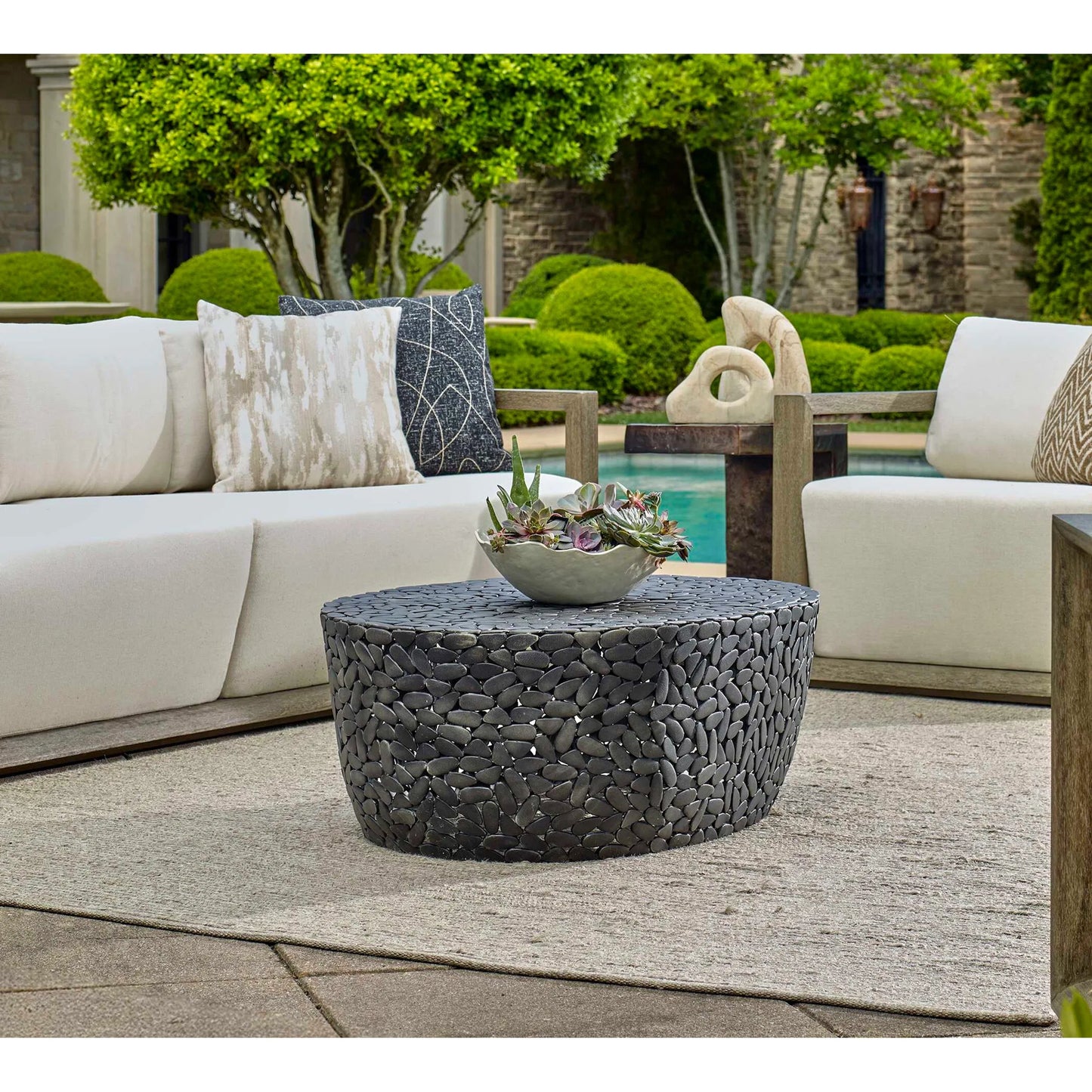003 SI-2386828 | Lifestyle | Rivington Outdoor Pebble Coffee Table by Uttermost in black. Made from aluminium in a unique style.