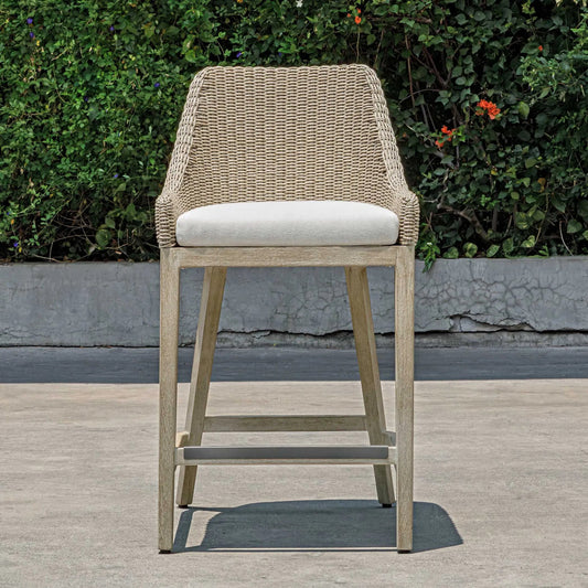 Paloma Outdoor Wicker Counter Stool by Uttermost in brown, gray, white and white. Made from mahogany wood, aluminum with wicker in a unique style.