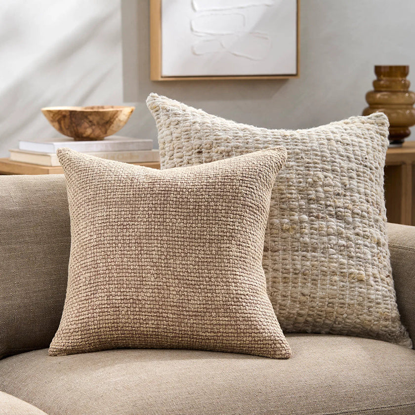 Textured decorative throw pillows in neutral tones, perfect for adding comfort and style to modern sofas and living rooms.