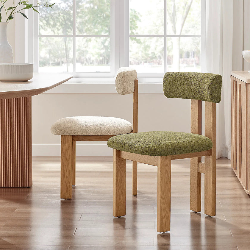 Modern dining chairs with soft boucle upholstery in neutral and green tones, paired with a wooden frame, adding a contemporary touch to any dining room.