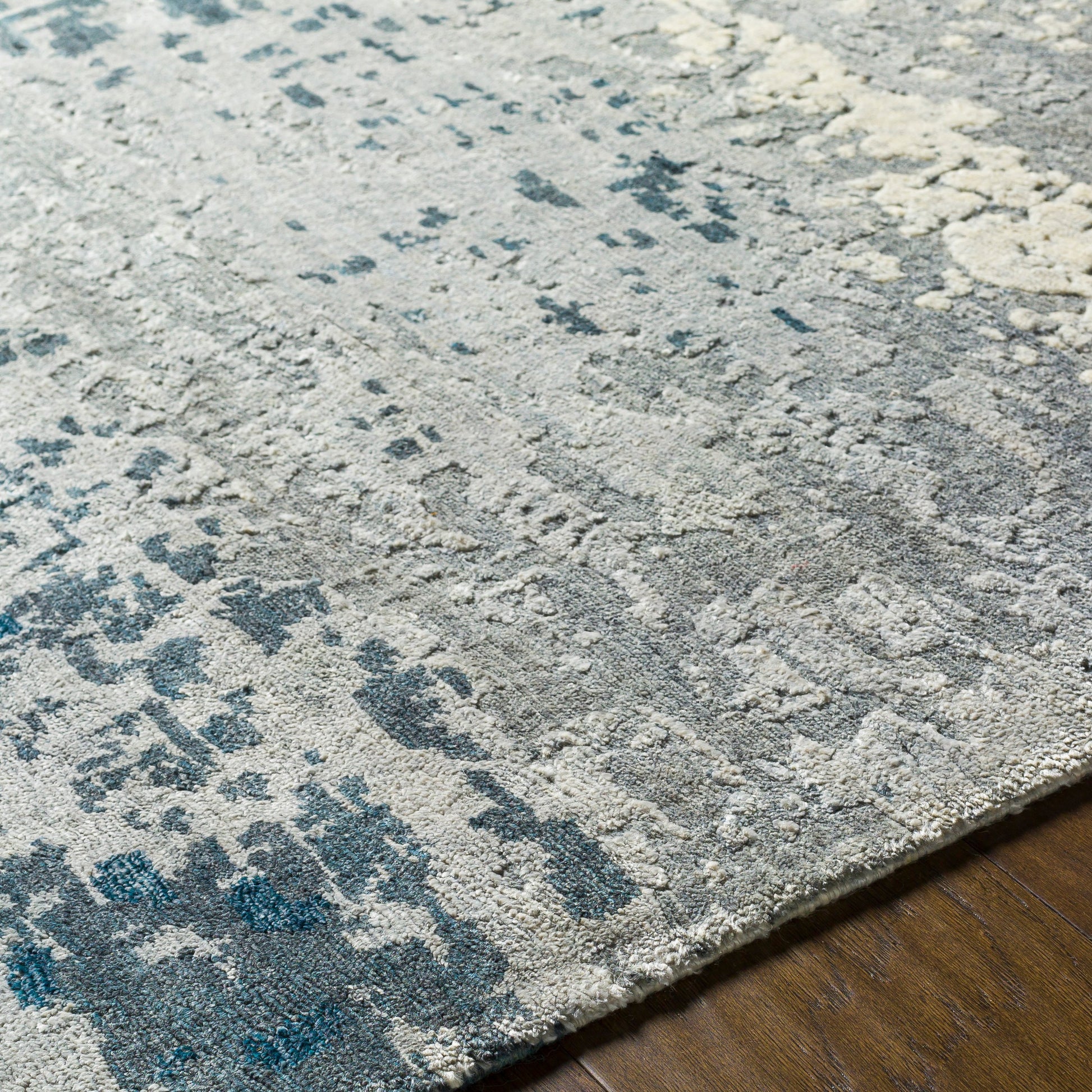 Imola Rug - 26077 by Surya in light beige, gray, light gray, dark blue, teal, charcoal. Made from 90% viscose, 10% nz wool in a unique style.