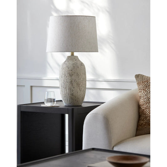 Judarn Table Lamp - 531750 by Livabliss in body: white, shade: beige, finial: metallic - brass, harp: metallic - brass, cord: translucent and coloredplated. Made from ceramic, linen, polyester, iron in a modern style.