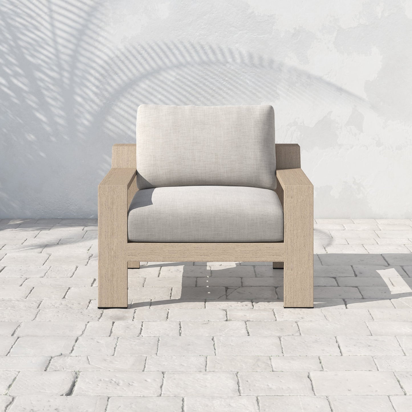 024 SR-712706 | Lifestyle | Monterey Outdoor Chair by Four Hands in stone gray, washed brown. Made from 100% olefin, solid fsc®-certified teak, 59% polyurethane foam, 30% polyester fiber, 11% polyester fiber batting in a coastal style.