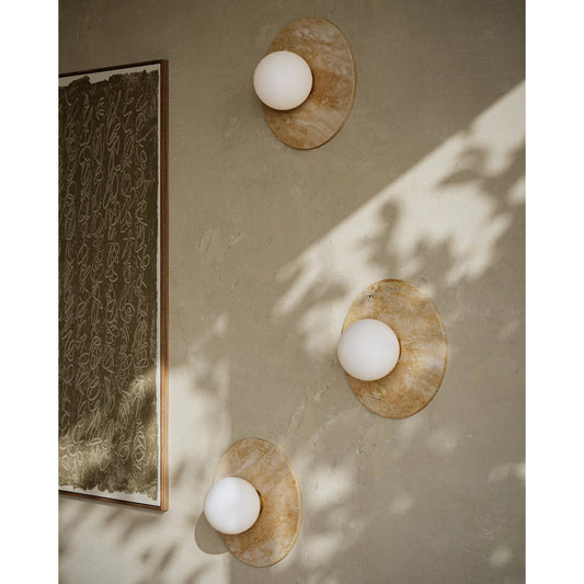 Apricity Wall Sconce by Currey and Company in beige, antique brass, frosted white. Made from travertine, metal, glass in a modern style.