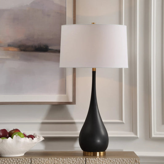 Nocturnal Table Lamp by Uttermost in brass. Made from mad-made stone, iron, fabric in a modern style.