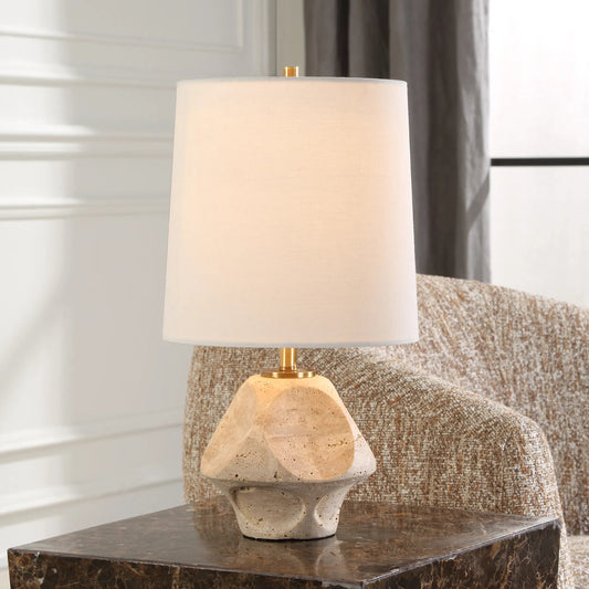 Indent Travertine Accent Lamp by Uttermost in brass. Made from iron, marble, fabric in a transitional style.