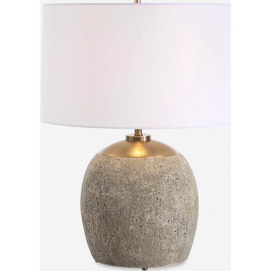 Raylan Textured Table Lamp by Uttermost in brass. Made from metal, cement, fabric in a modern style.