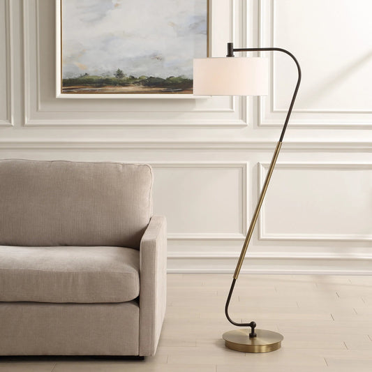 Irwin Curved Floor Lamp by Uttermost in antique brass. Made from steel, fabric in a transitional style.