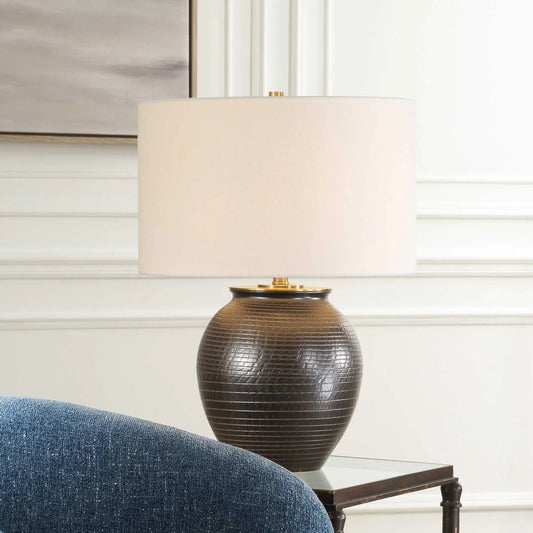Hawkins Ribbed Table Lamp by Uttermost in dark bronze. Made from steel, ceramic, fabric in a rustic style.