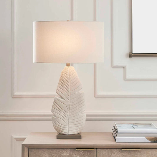 Palm Leaf Table Lamp by Uttermost in white and brass. Made from ceramic, fabric, galvanized steel in a unique style.