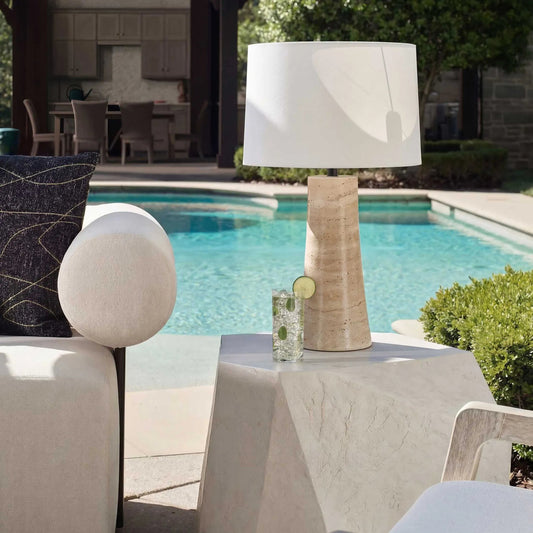 Delmani Indoor/Outdoor Lamp by Uttermost in dark. Made from travertine, iron, fabric in a unique style.