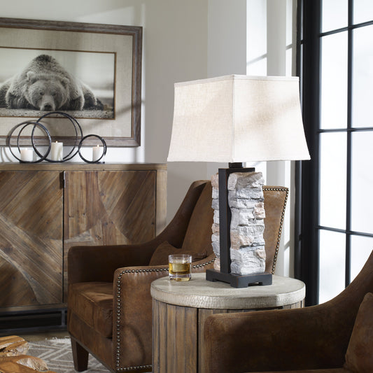 Kodiak Stacked Stone Lamp by Uttermost. Made from concrete, steel, fabric, glass in a rustic style.