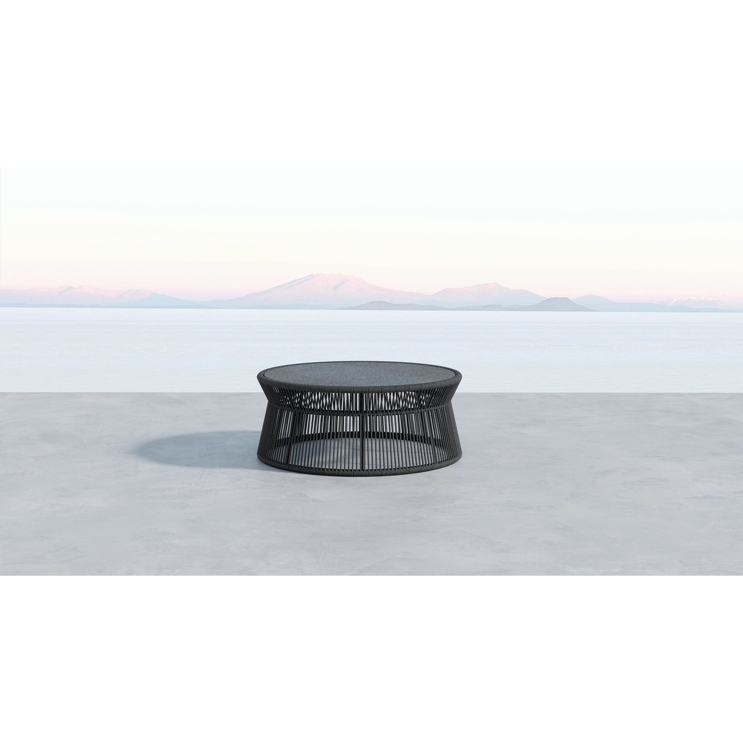 003 SI-2167031 | Lifestyle | Milano Outdoor 40" Round Coffee Table by Sunset West in slate. Made from olefin rope in a coastal style.