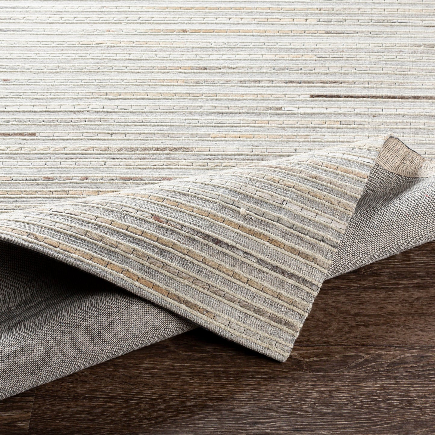 007 SI-1886215,SI-1886217,SI-1886218 | Closeup | Medora Rug - 26072 by Surya in taupe, dark brown, oatmeal, black, medium gray. Made from 50% wool, 30% hair on hide, 20% viscose in a unique style.